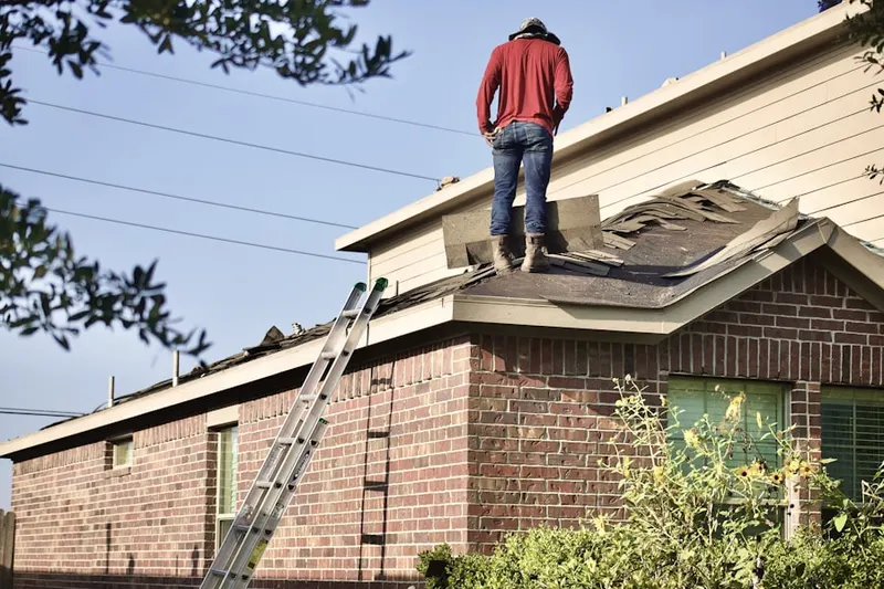 Professional roofer working on a residential roof in Northwest Harbor